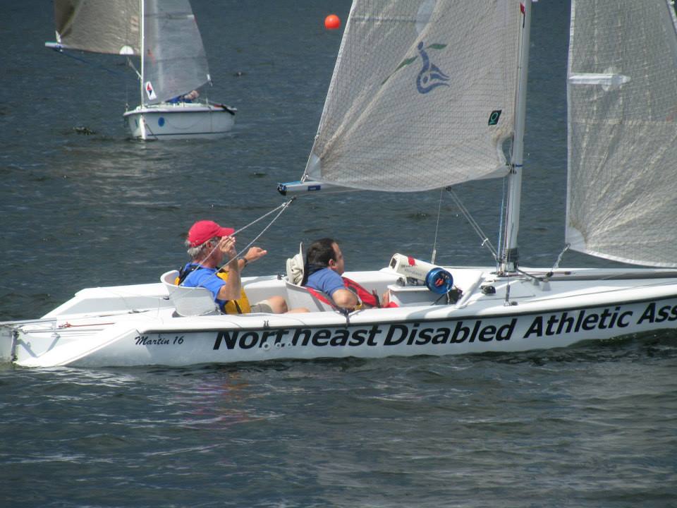 Adaptive Martin 16 sailboat. Sail has NDAA logo