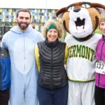 Nancy Gell and Sue Kasser pose with DPT students and UVM mascot Charlie Catamount