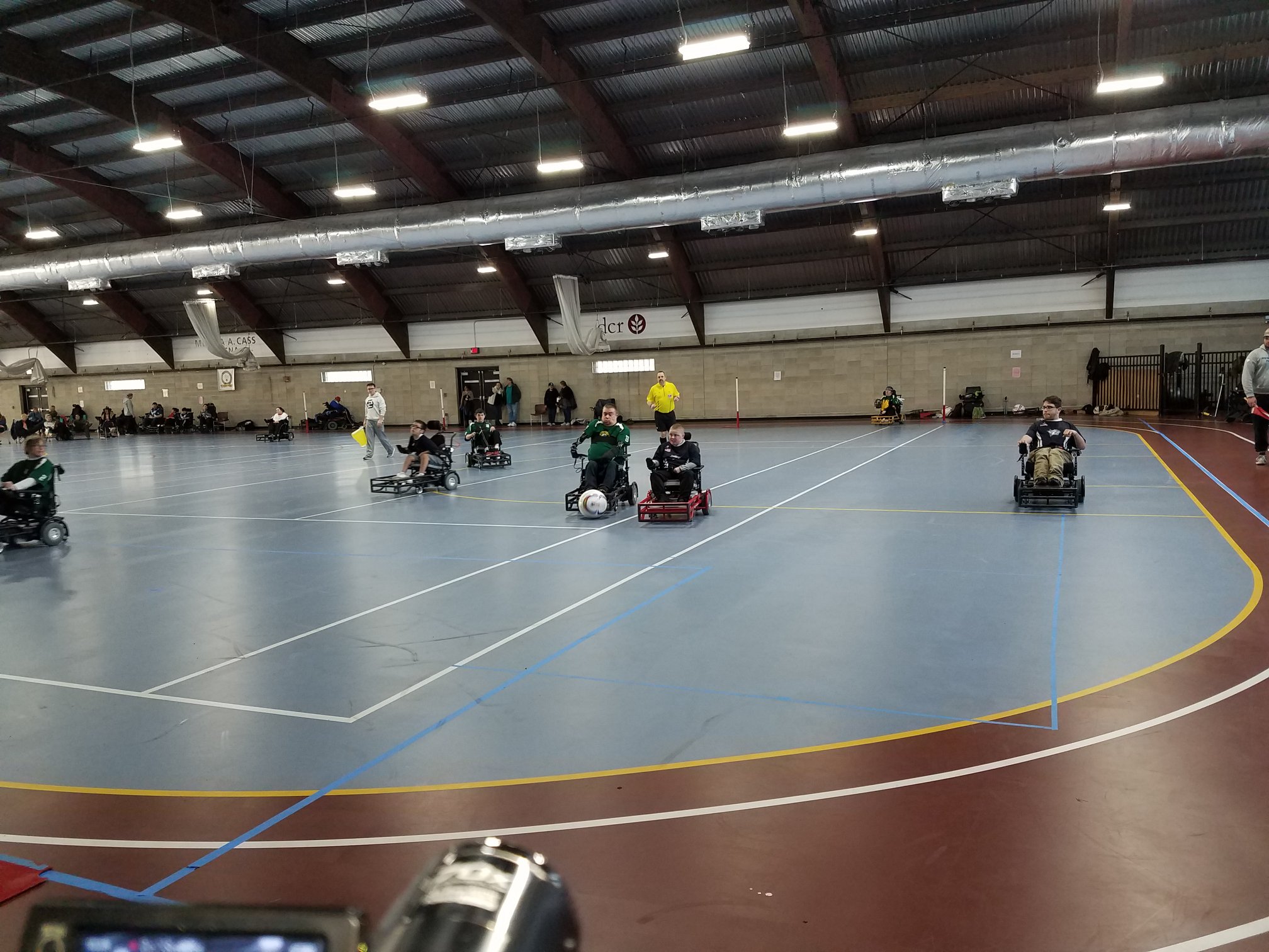 Power soccer players play on a hard court