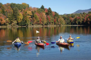 Four people in adaptive kayaks on waterbury reservoir