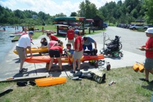 Kyle preparing to launch an adaptive kayak alongside NDAA volunteers