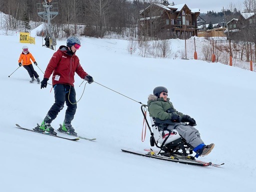 Skiier being tethered by TetraSki instructor
